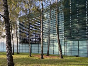 Green building facade for the Nordic Embassies in Berlin with trees and opened louvers.