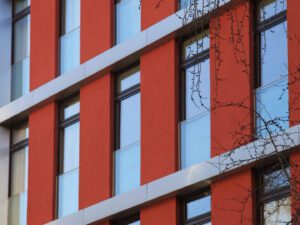 The modern façade of the Bandit Building at Röntgenstraße 14a in Berlin-Charlottenburg, featuring a mix of materials and large windows.