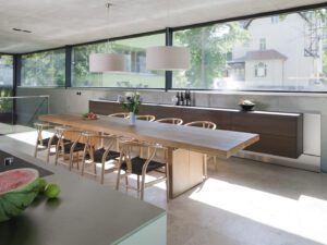 Open-plan living area with natural materials and expansive glazing