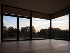 Open-plan living, dining, and kitchen area with large windows