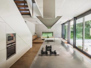 Open-plan kitchen and dining area with large windows overlooking the garden