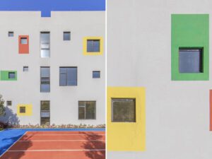 Close-up of the kindergarten's facade with varied window sizes and colourful accents