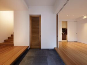 Modern detached house with grey plastered facade and large panoramic window
