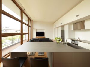 Spacious open-plan living, dining, and kitchen area with high ceiling