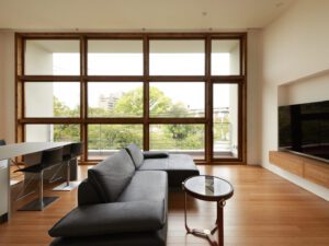 Panoramic view from upper floor with large windows overlooking the park and city