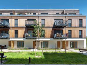 Facade of the front building in the Climate Positive Living building, showcasing the timber panel elements
