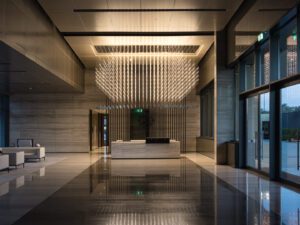 Lobby with pendant light and white sofa of Assila Investment HQ in Riad.
