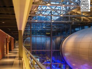 Interior of a factory with two sphere conference hall and mood lighting for Xintiandi Factory Hangzhou and DAM Preis nomination logo.